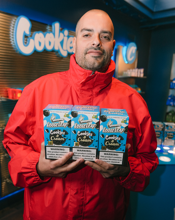 BURNER holding multiple boxes of 'Cookie Cookies & Cream' Loose Leaf